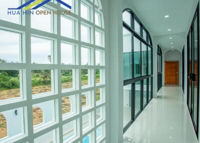 Modern hallway with large windows and glass doors