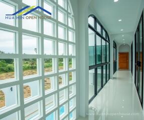 Modern hallway with large windows and glass doors