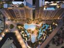 Aerial view of a residential complex with pools and landscaped areas