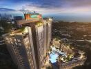 Aerial view of a modern high-rise residential building with a pool area