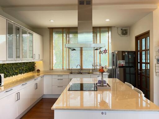 Spacious modern kitchen with island and large windows