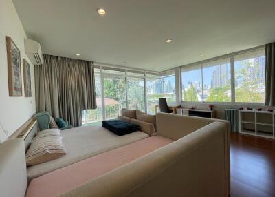 Spacious living room with large windows and city view