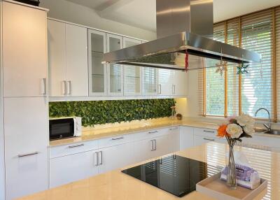 Modern white kitchen with appliances and floral decor