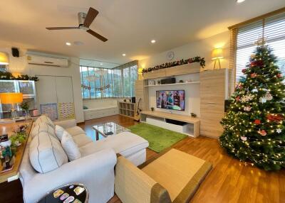 Spacious living room with Christmas decorations, a large sofa, and a TV unit