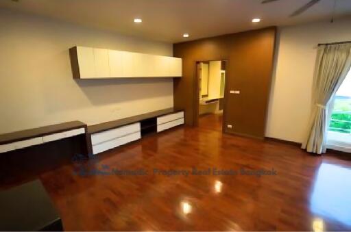 Spacious living room with hardwood floors and large window