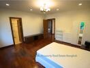 Spacious bedroom with hardwood floors and ample storage