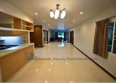 Spacious living and dining area with modern fixtures and ample lighting