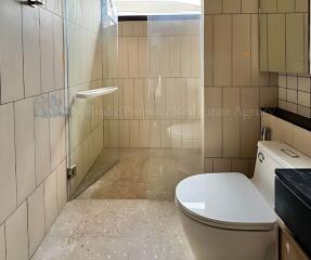 Modern bathroom with glass shower and toilet