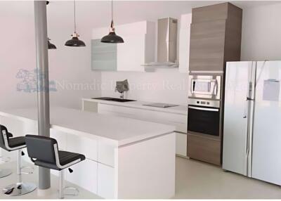 Modern kitchen with island, stainless steel appliances, and barstool seating