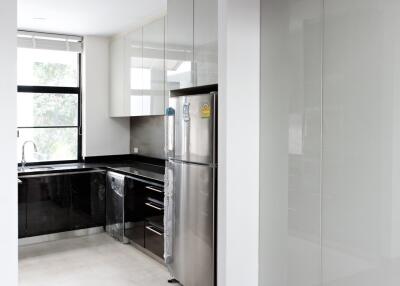 Modern kitchen with stainless steel appliances and large window