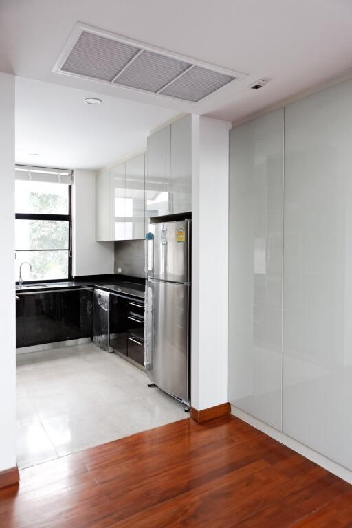 Modern kitchen with stainless steel appliances and large window