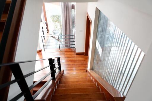 Elegant wooden staircase with modern railing