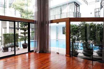 Spacious living area with pool view and natural light