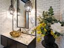 Stylish modern bathroom with marble countertop and floral arrangement