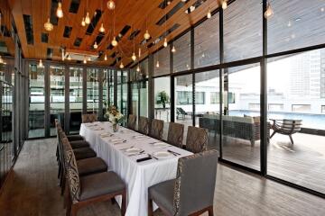 Elegant dining area with large windows and pool view