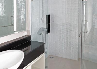 Modern bathroom with glass shower and vessel sink