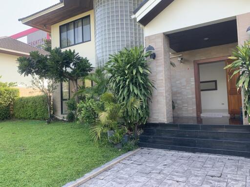 Exterior view of a house with garden and pathway