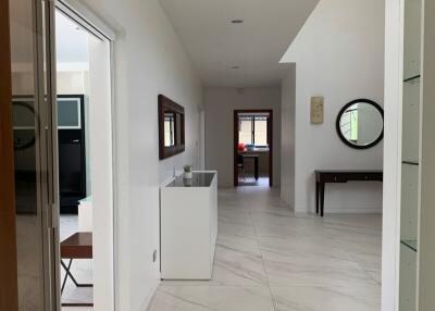 Modern hallway with white walls and tiled floor