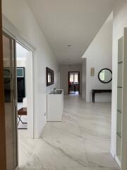 Modern hallway with white walls and tiled floor