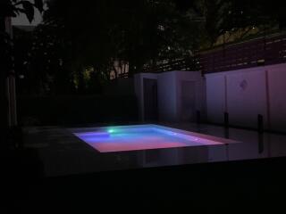 Outdoor pool area lit up at night