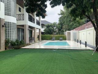 Backyard with pool and greenery