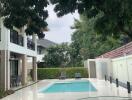 Outdoor area with swimming pool and lounge chairs