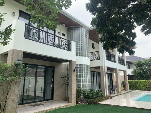 Modern two-story house with a pool and garden