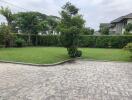 Well-maintained garden with lawn and paving