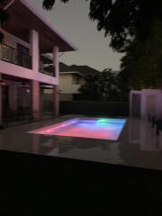 Outdoor area with illuminated swimming pool at dusk