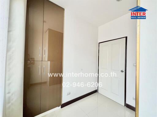 Bedroom with a white door, built-in wardrobe, and bright lighting