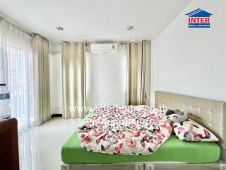 Bright bedroom with double bed and curtains