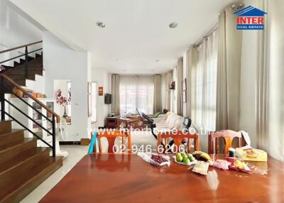 Spacious and well-lit living room with dining area