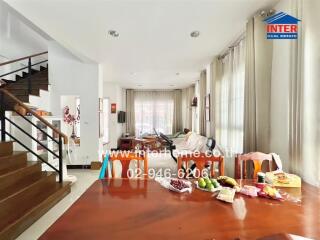 Spacious and well-lit living room with dining area