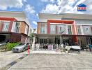 Modern townhouse front view with parked cars and clear sky