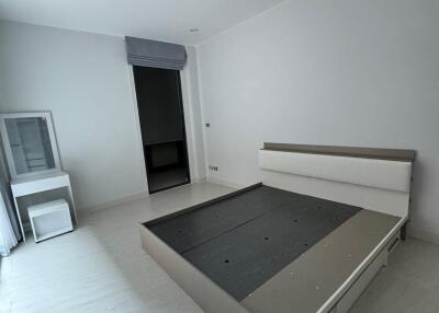 Minimalist bedroom with a bed frame, window and small nightstand