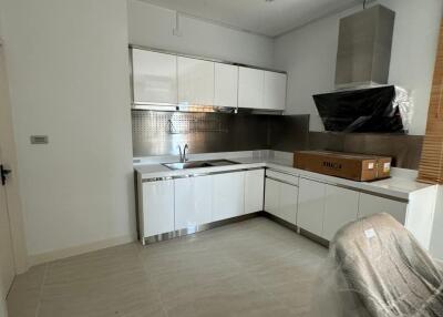 Modern kitchen with white cabinets and stainless steel appliances