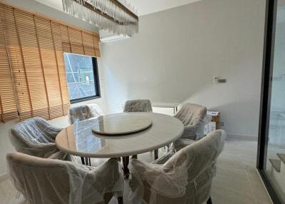 Modern dining room with circular table and chandelier