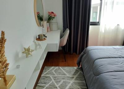 Bedroom with a desk, chair, and window