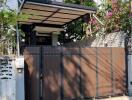 Modern house exterior with a gated entrance and balcony