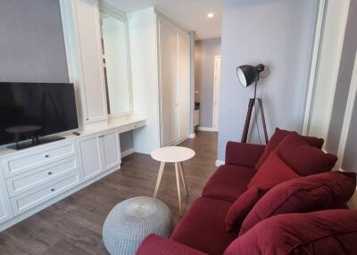 Modern living room with red sofa and TV