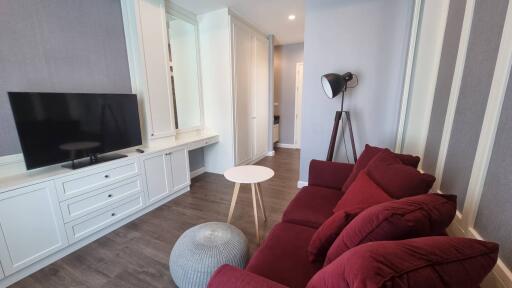 Modern living room with red sofa and TV