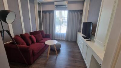 modern living room with red sofa and TV