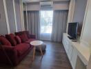 modern living room with red sofa and TV