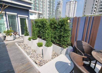 Modern outdoor patio with greenery and city view