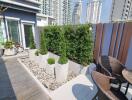 Modern outdoor patio with greenery and city view