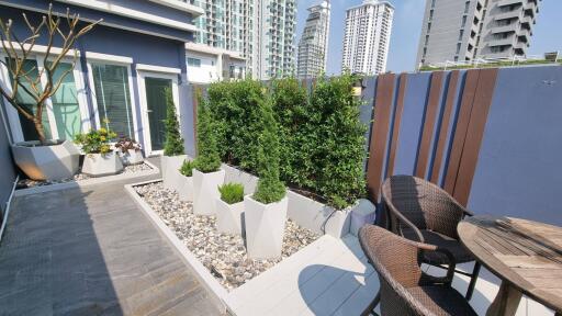 Modern outdoor patio with greenery and city view