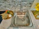 Modern kitchen sink with stylish backsplash and decorative items