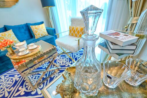 Cozy living room with blue sofa, glass table, and decorative items