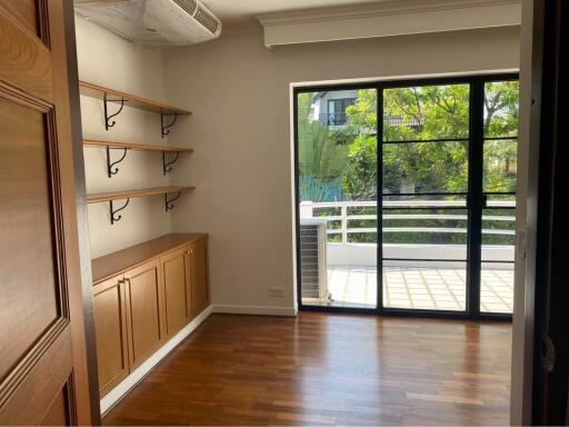 Bedroom with balcony and built-in shelves