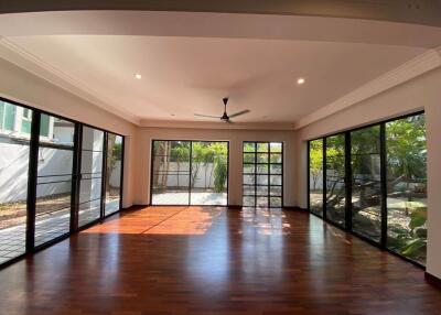 Spacious living room with large windows and garden view